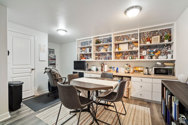 Dining area featuring light wood-style flooring and an office area