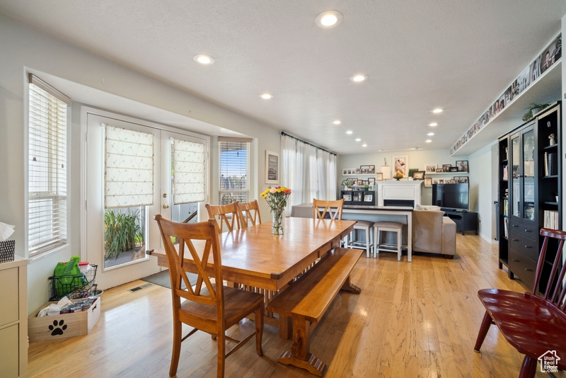 Dining room with light wood-type flooring and recessed lighting