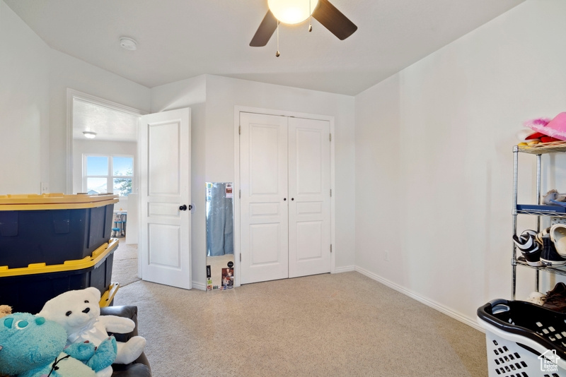 Game room featuring carpet floors, ceiling fan, and baseboards