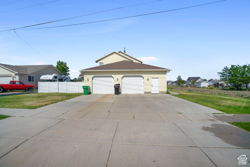 Garage featuring concrete driveway