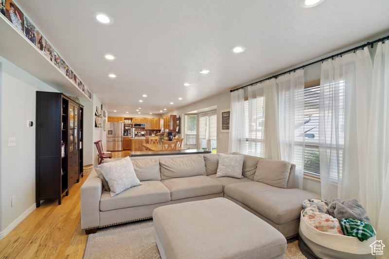 Living area featuring recessed lighting, light wood finished floors, and baseboards