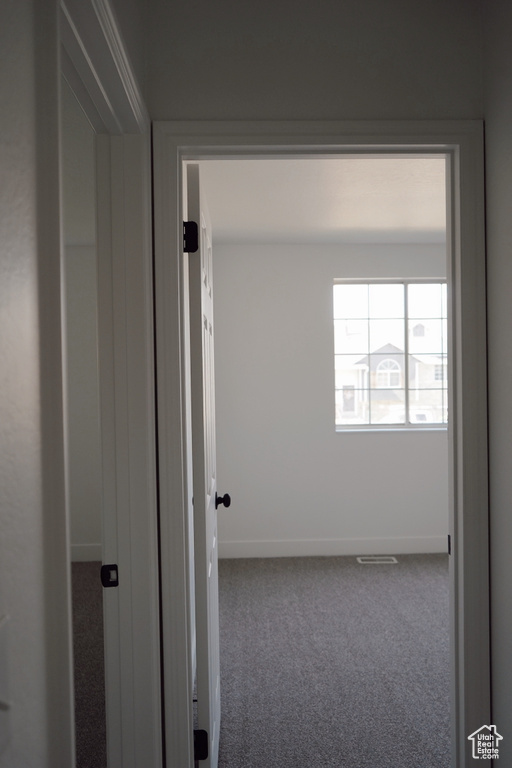 Spare room featuring carpet and baseboards