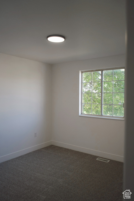 Spare room with carpet and baseboards