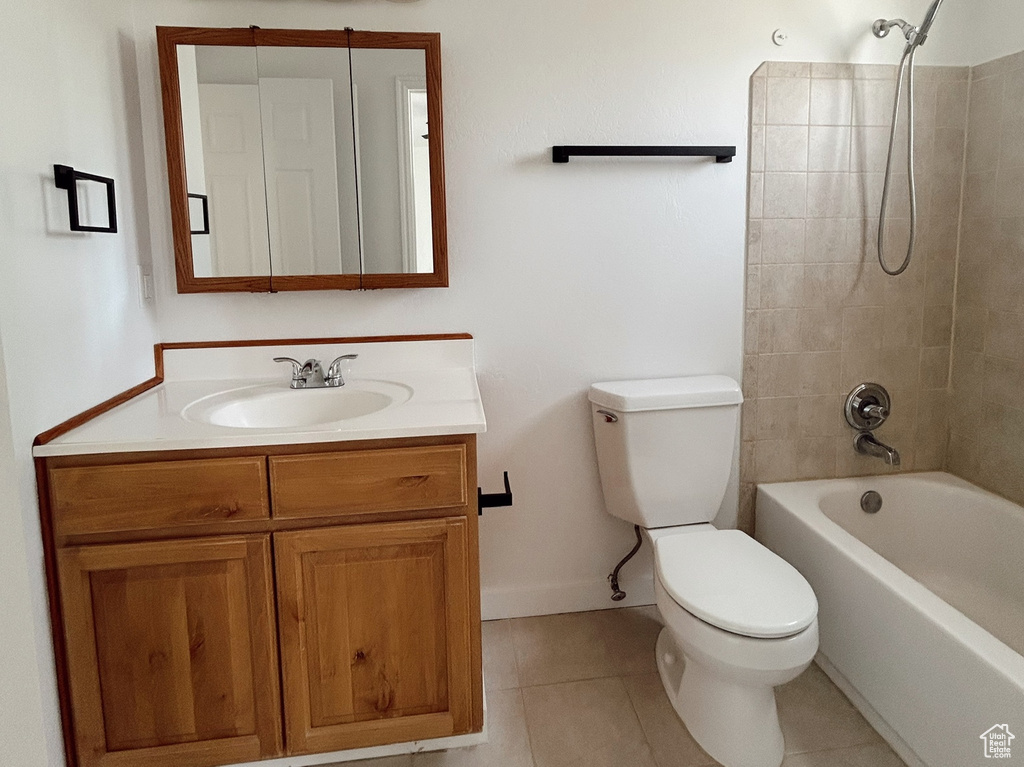 Full bath featuring toilet, shower / bath combination, vanity, tile patterned flooring, and baseboards