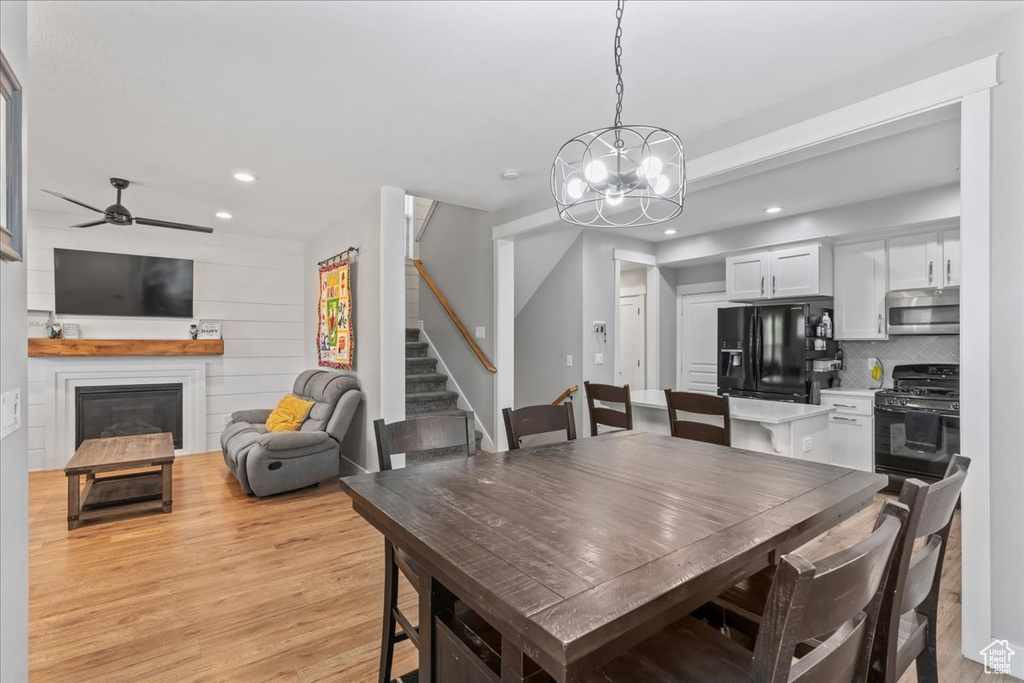 Dining space with stairway, recessed lighting, light wood-style flooring, a chandelier, and ceiling fan