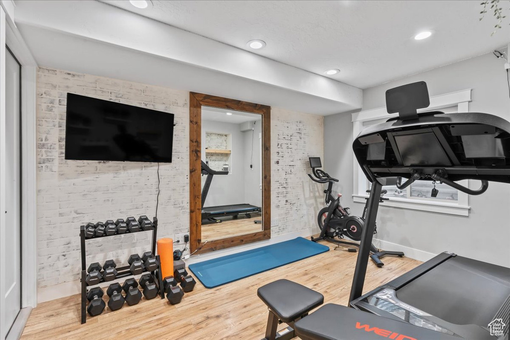 Exercise area featuring wood finished floors, recessed lighting, and baseboards