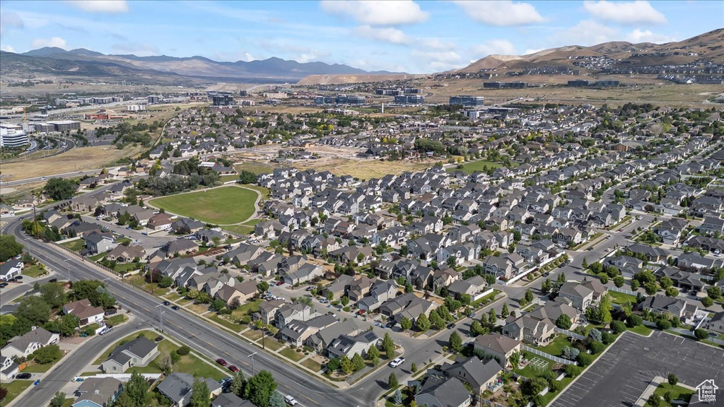 Aerial view of property\'s location featuring a mountainous background