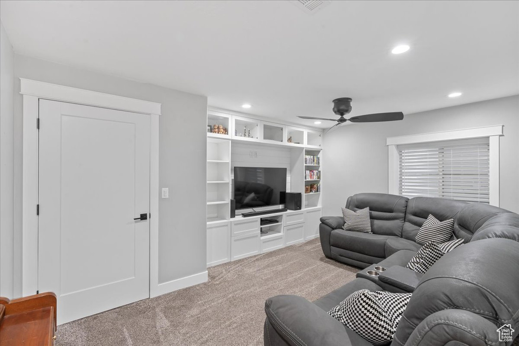 Living area with light carpet, a ceiling fan, recessed lighting, and baseboards