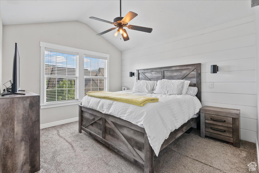 Bedroom featuring carpet flooring, lofted ceiling, baseboards, and ceiling fan