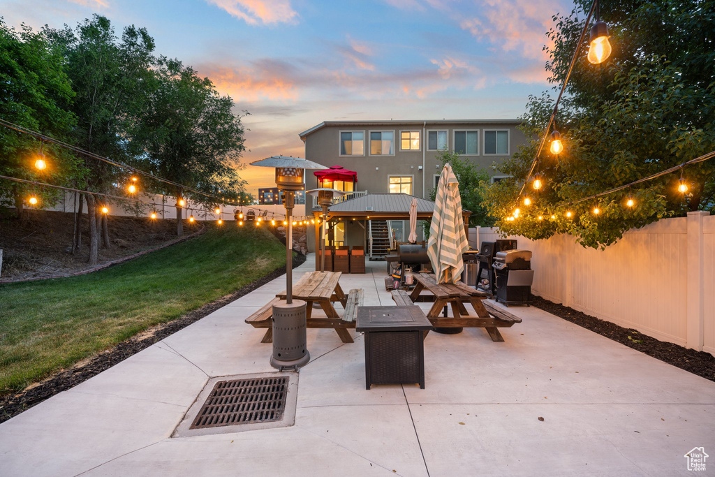 Patio terrace at dusk with a patio area and an outdoor living space with a fire pit