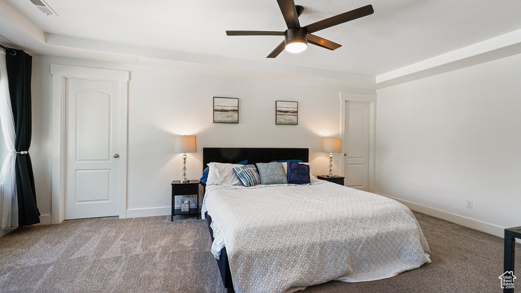 Carpeted bedroom with baseboards and ceiling fan