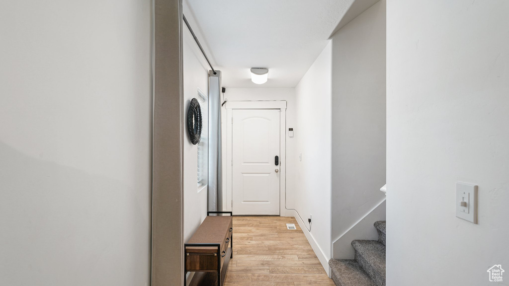 Hall featuring light wood-style floors and stairway