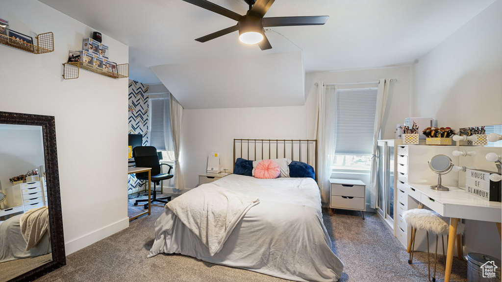 Bedroom with carpet, a desk, ceiling fan, and baseboards