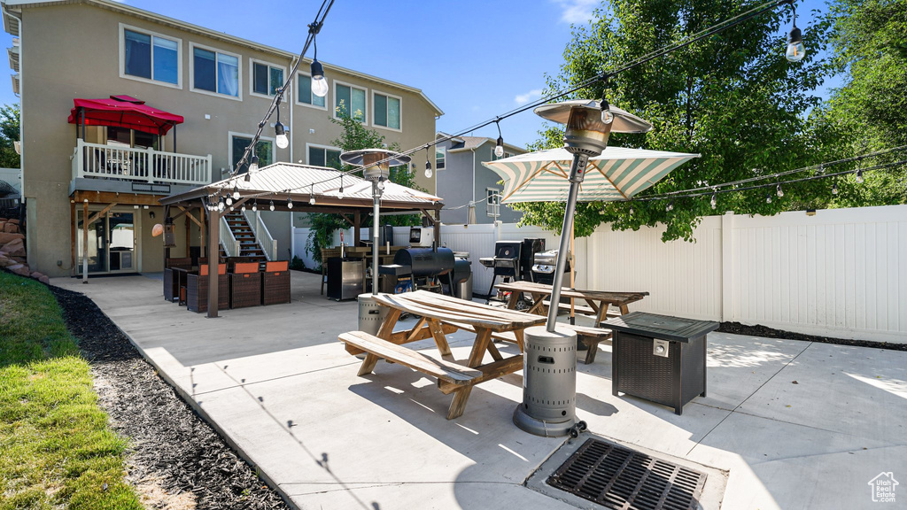 View of patio / terrace featuring a gazebo, an outdoor living space, stairs, and outdoor dining space