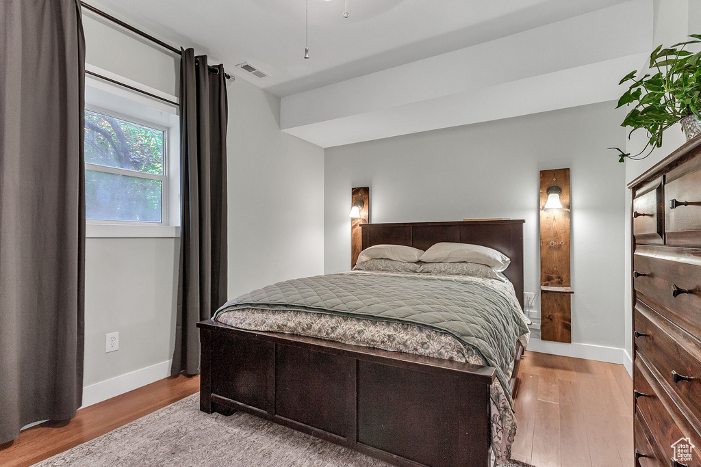 Bedroom featuring wood finished floors and baseboards