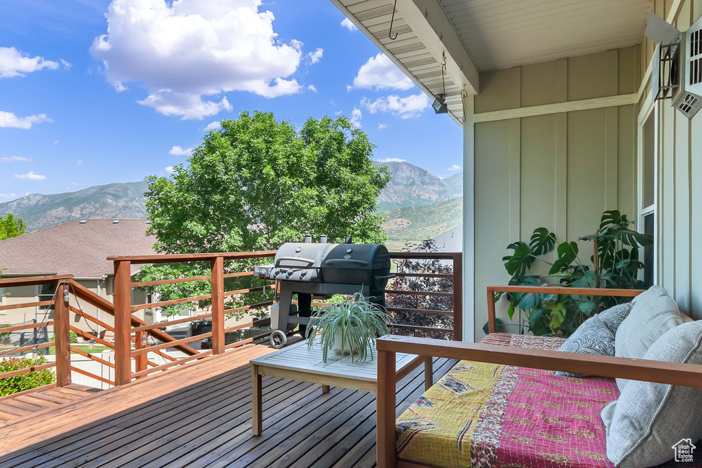 Wooden terrace featuring area for grilling and a mountain view