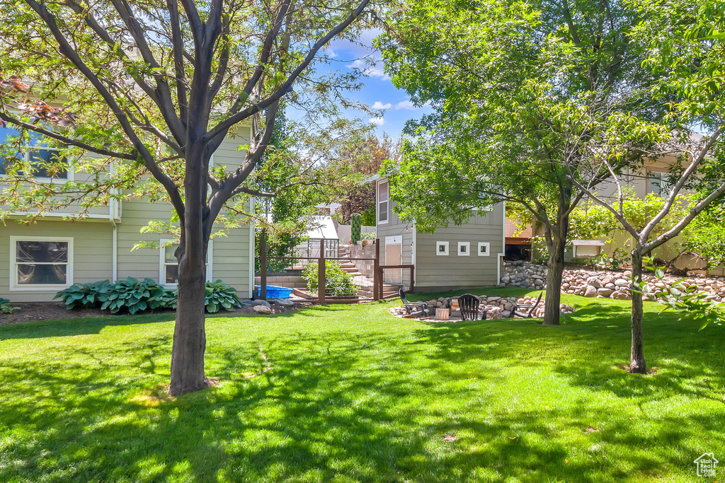 View of green lawn with a fire pit