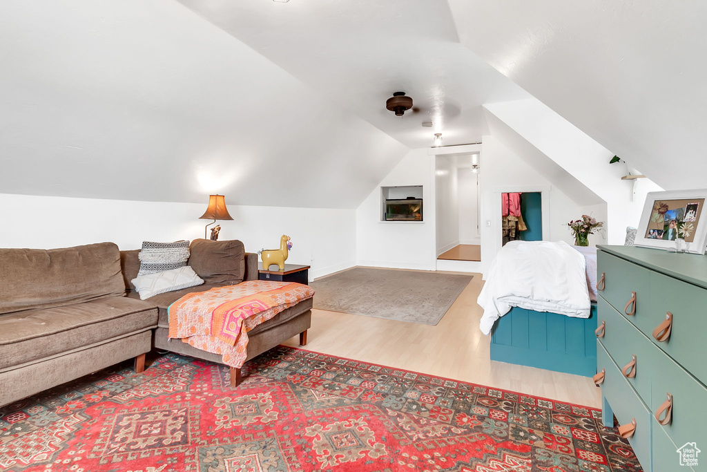 Bedroom with wood finished floors and vaulted ceiling