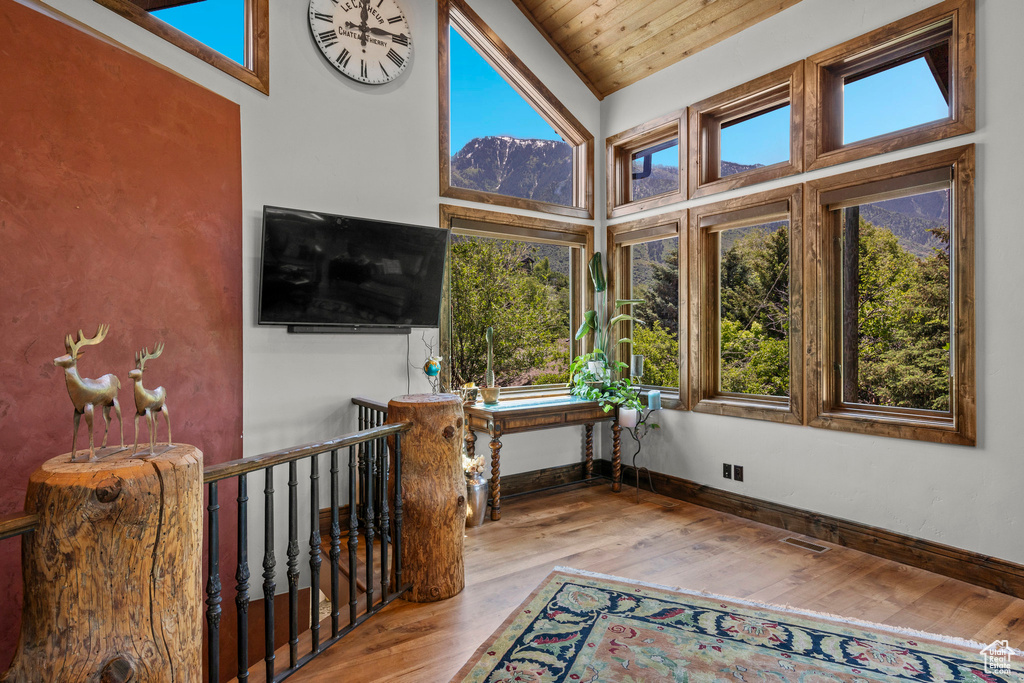 Sunroom featuring plenty of natural light and lofted ceiling