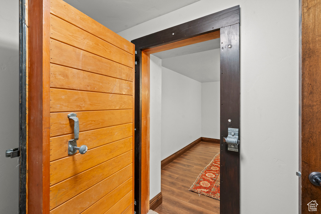 Hallway featuring wood finished floors and baseboards