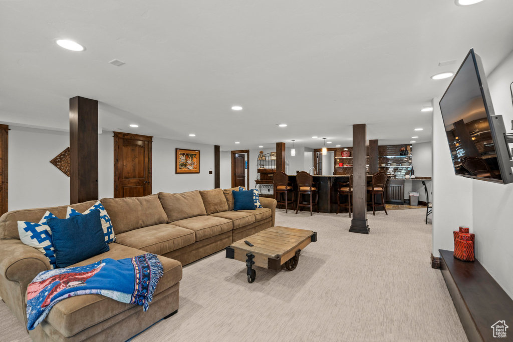 Living room with recessed lighting, carpet, and bar