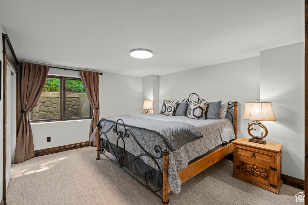 Bedroom featuring baseboards and carpet flooring