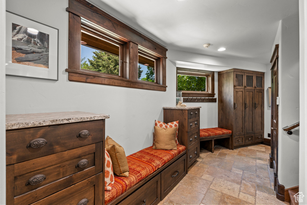 Mudroom with stone tile floors and recessed lighting