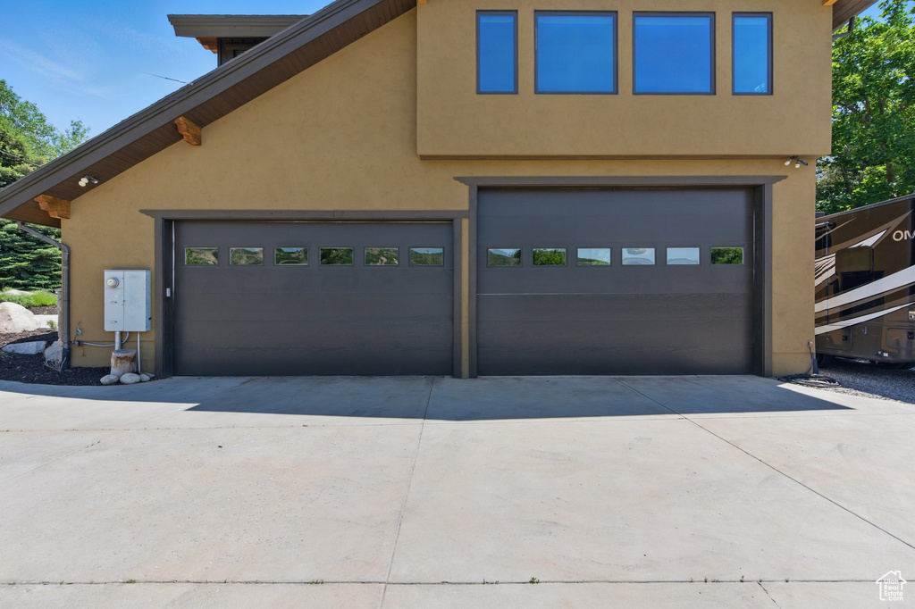 Garage featuring concrete driveway