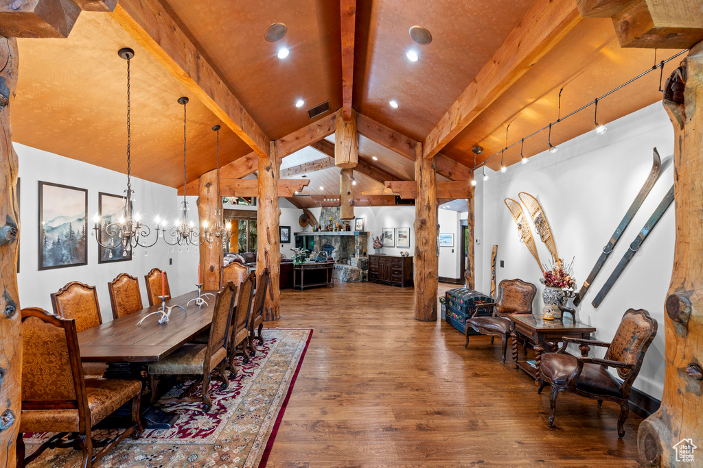 Dining room with wood-type flooring and a chandelier
