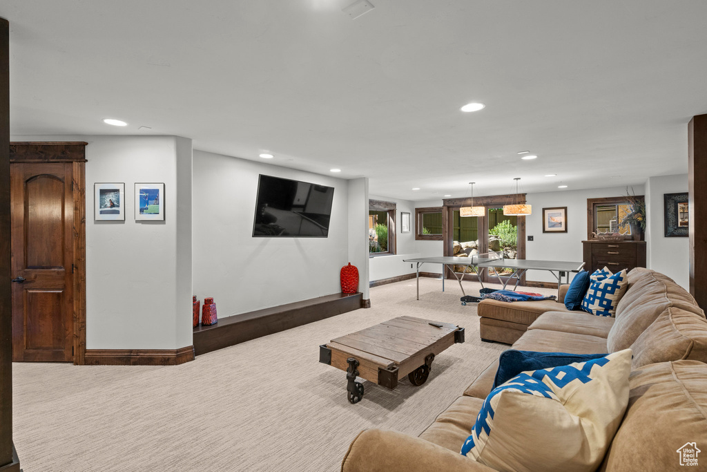 Living area with carpet flooring, recessed lighting, and baseboards