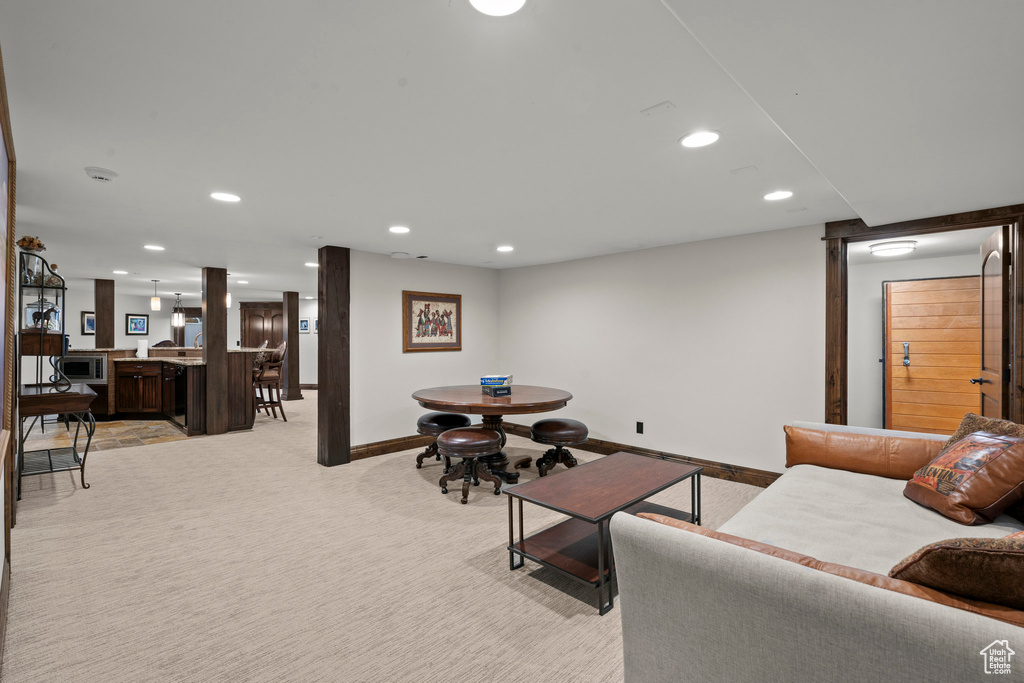 Living room with recessed lighting, light carpet, and baseboards