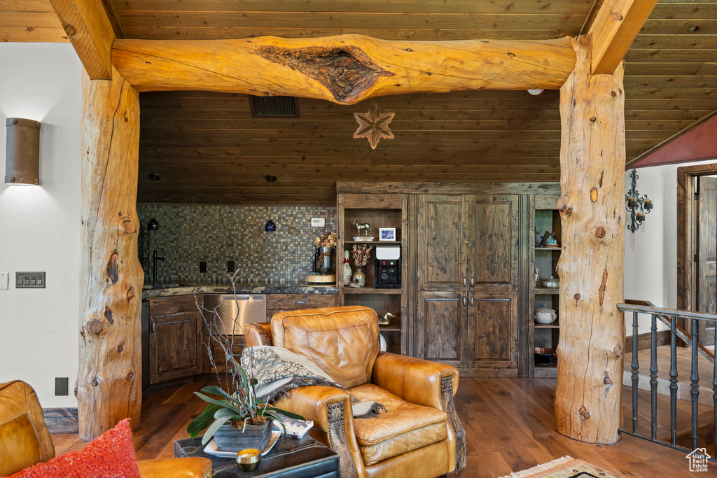 Living area with hardwood / wood-style floors and wooden ceiling with exposed beams