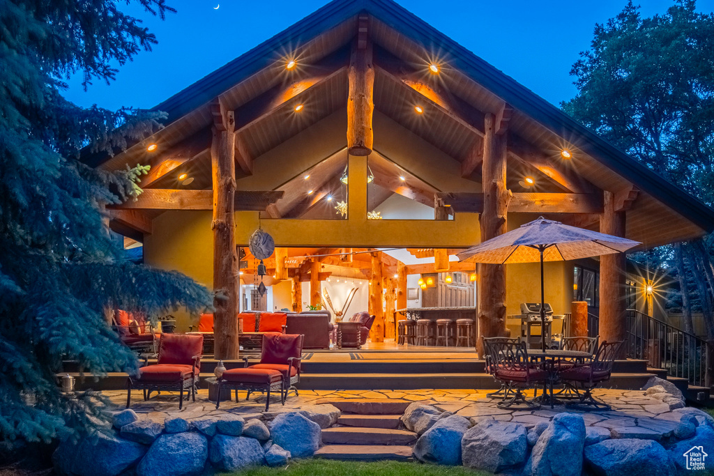 Rear view of house with a patio and outdoor dining area