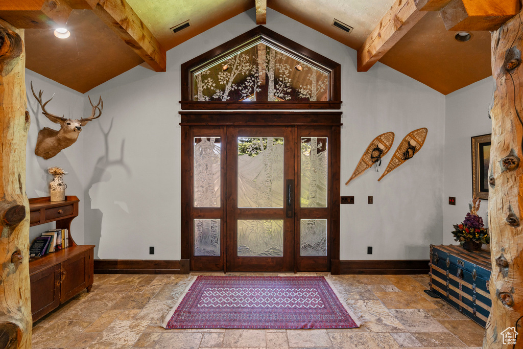 Entrance foyer with stone tile floors and baseboards