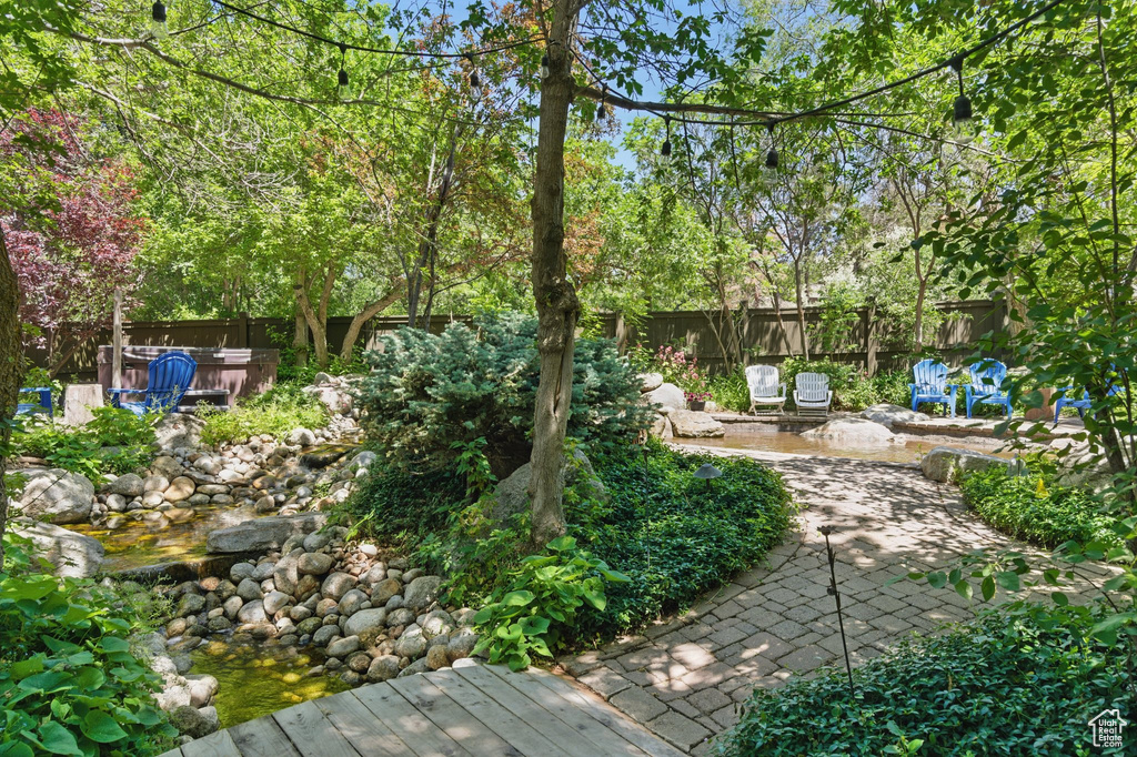 Fenced backyard featuring a patio and a jacuzzi