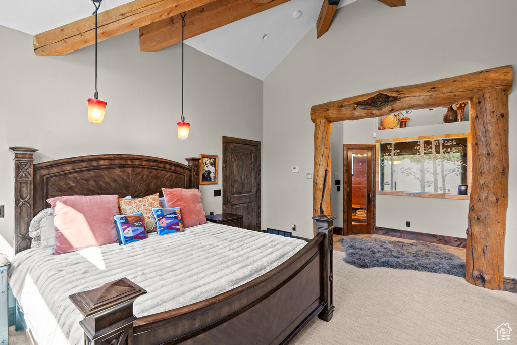 Bedroom featuring beam ceiling, high vaulted ceiling, and light carpet