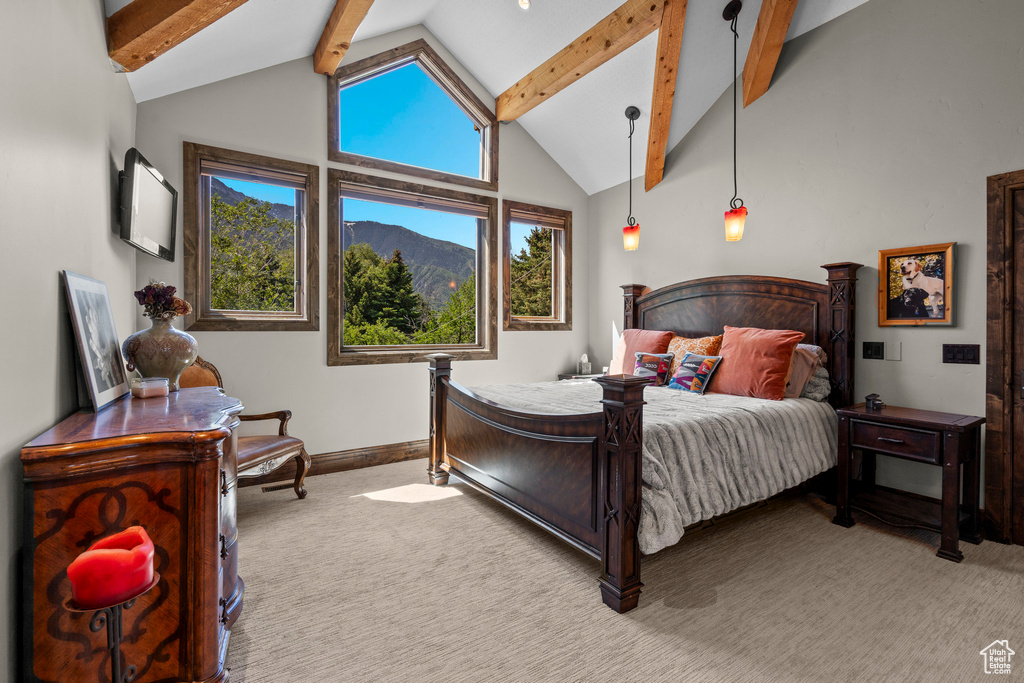 Carpeted bedroom featuring beamed ceiling, baseboards, and high vaulted ceiling