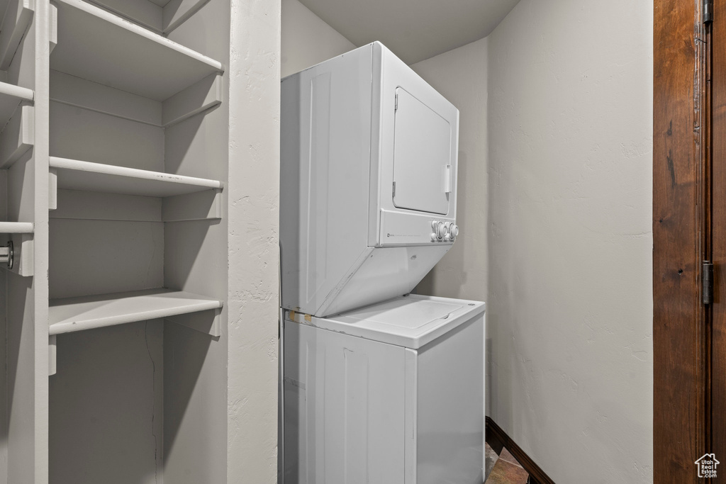 Laundry area featuring stacked washer / drying machine