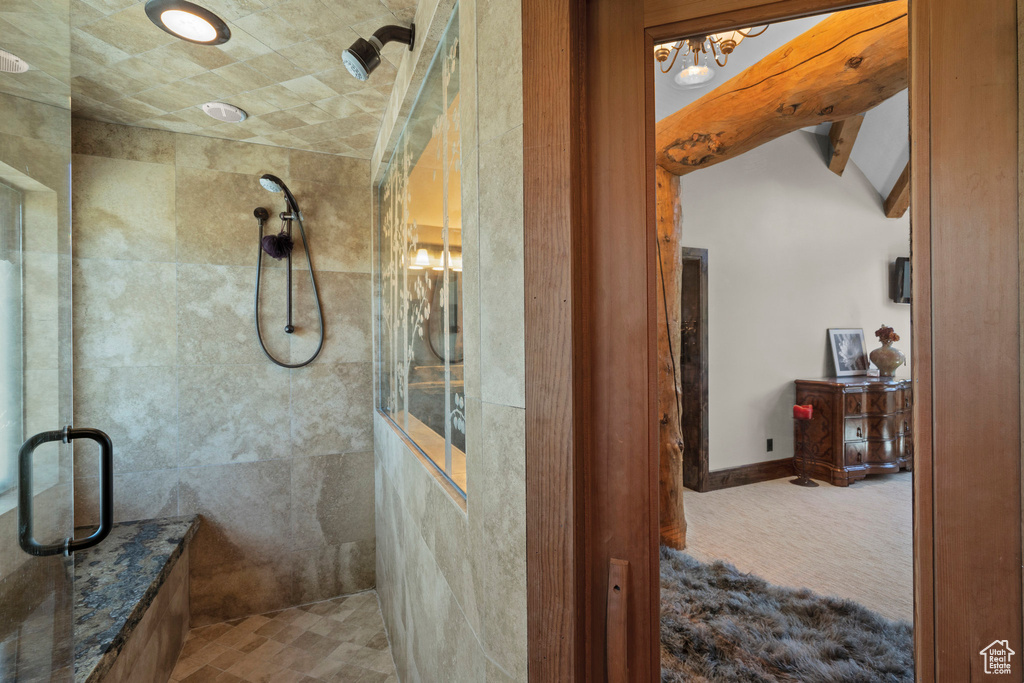 Full bathroom featuring a stall shower and a chandelier