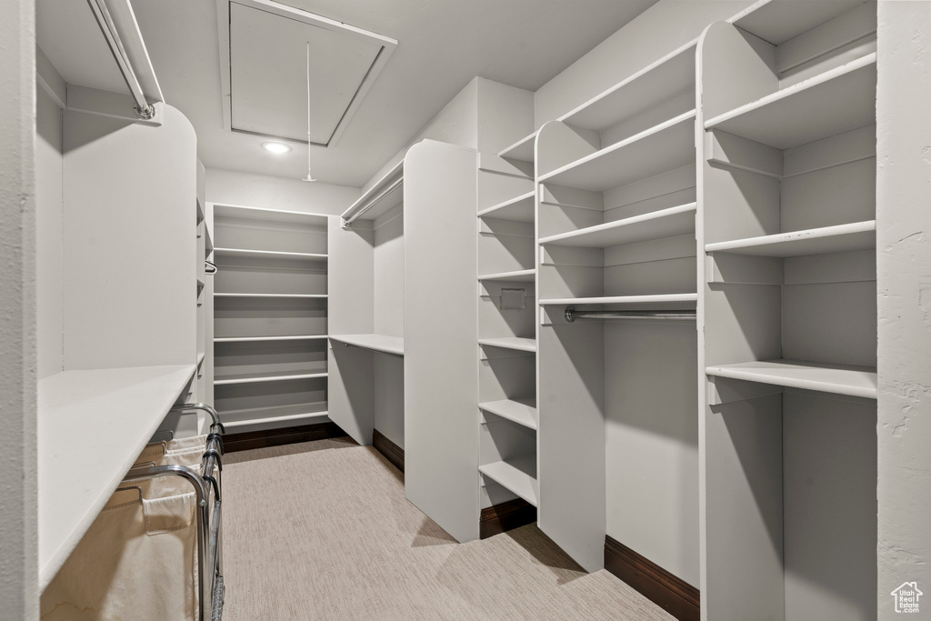 Spacious closet featuring attic access