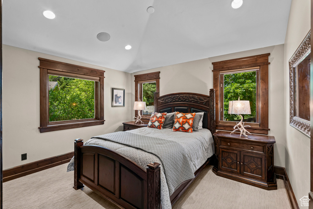 Bedroom featuring vaulted ceiling, multiple windows, baseboards, recessed lighting, and carpet
