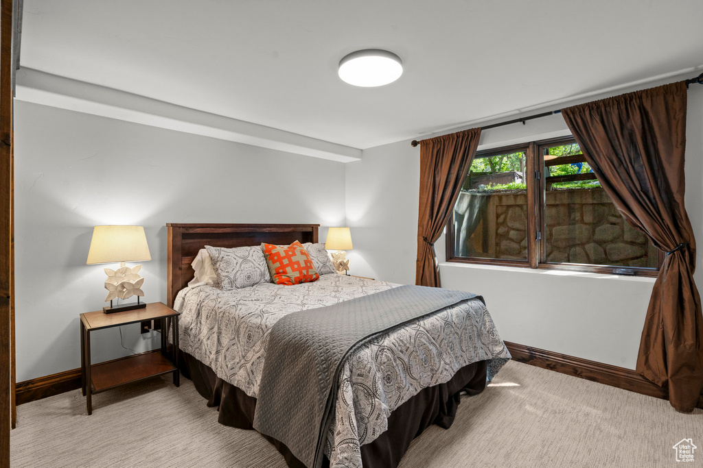Carpeted bedroom with baseboards