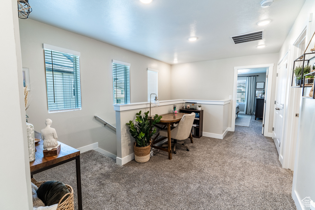 Office with carpet floors, healthy amount of natural light, and baseboards