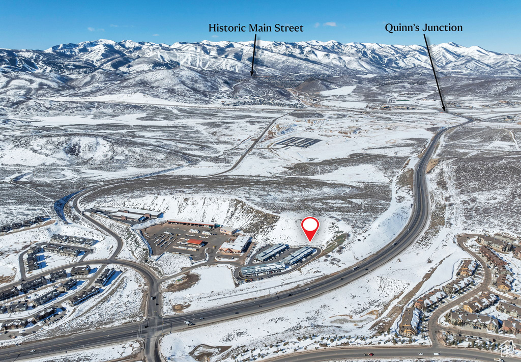Snowy aerial view featuring a mountain view