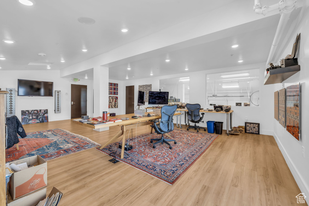 Office space featuring wood finished floors, recessed lighting, and baseboards