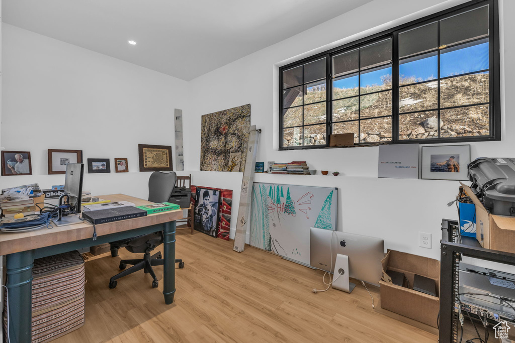 Office space featuring wood finished floors and recessed lighting