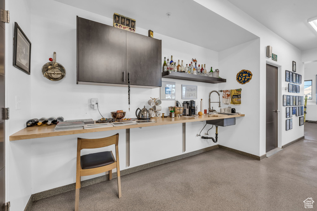 Bar featuring a sink and baseboards