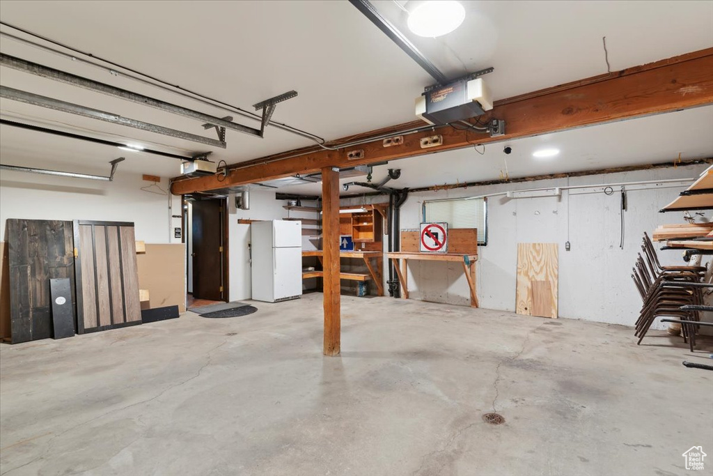 Garage featuring freestanding refrigerator