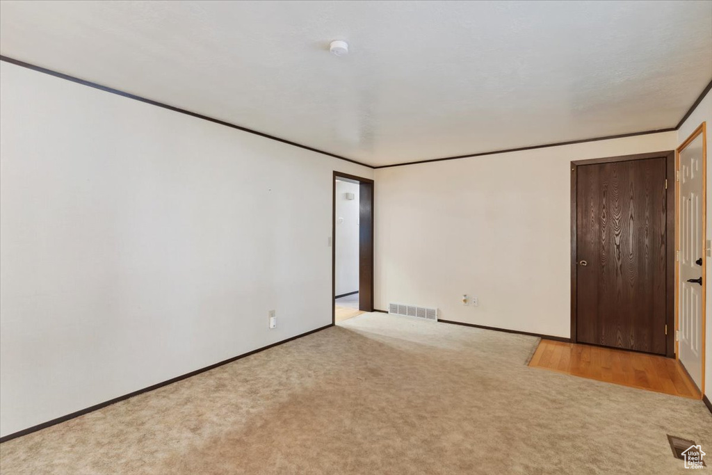 Unfurnished room with carpet, baseboards, and a smoke detector