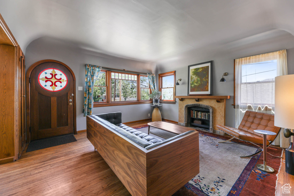 Living area with hardwood / wood-style flooring, a fireplace, and baseboards